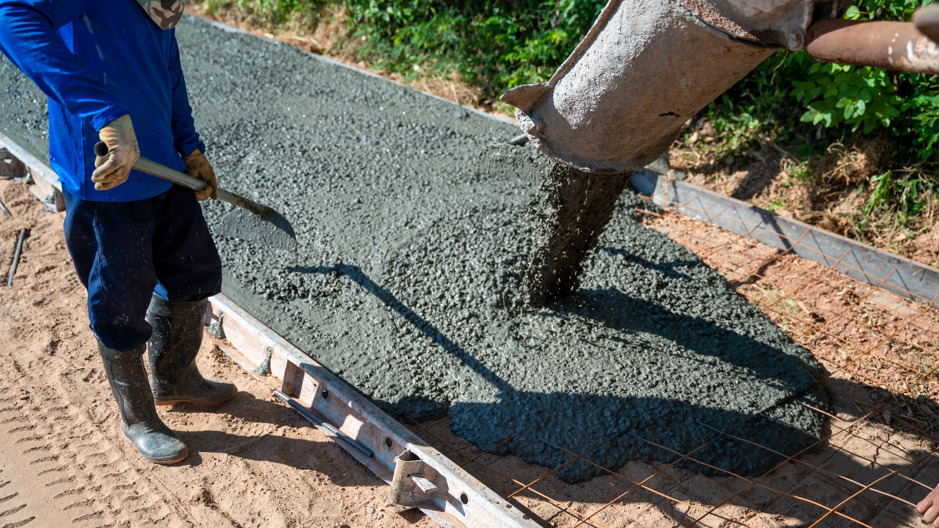 Concrete workers pouring slab foundation